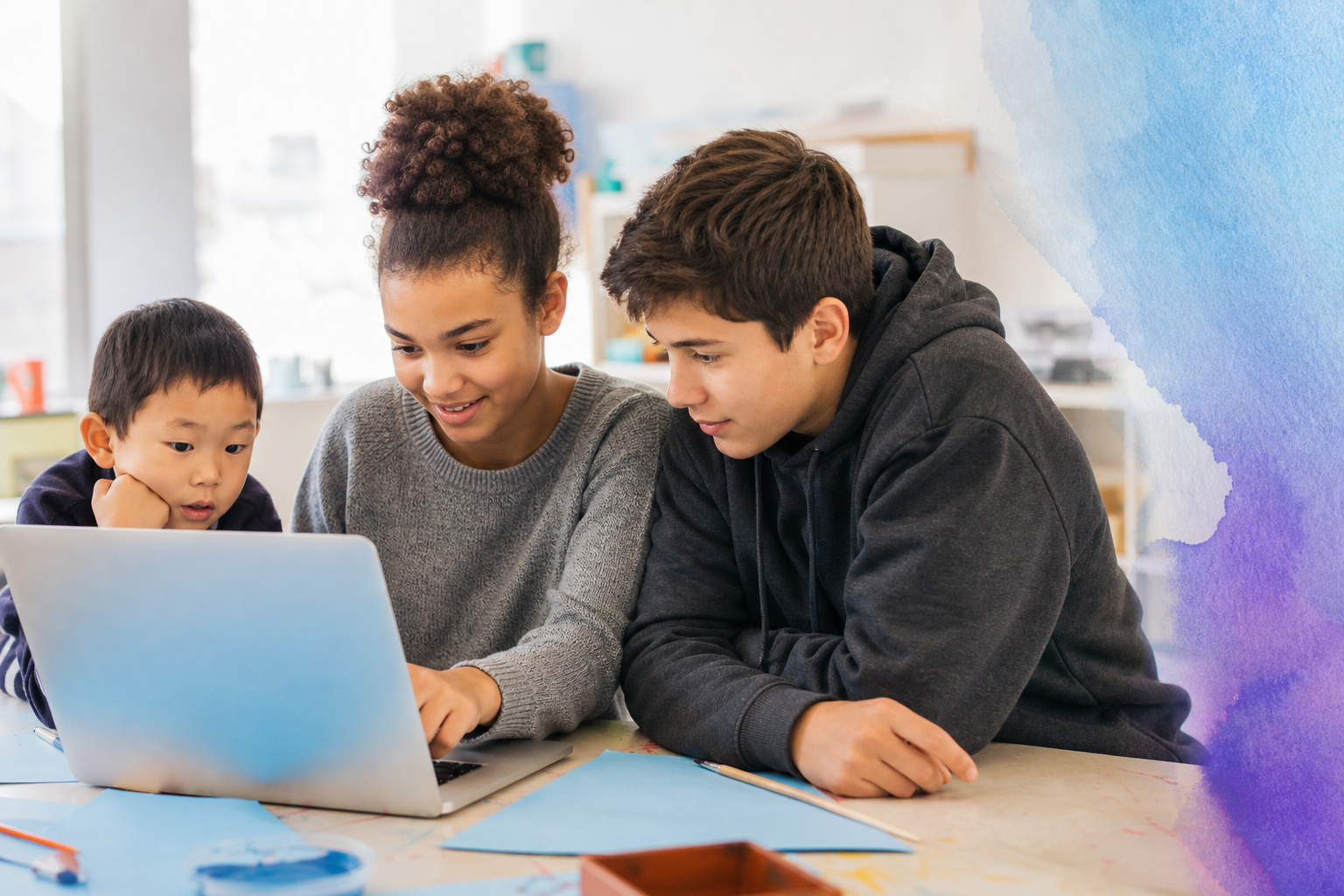 Three students of different ages learning together with a laptop